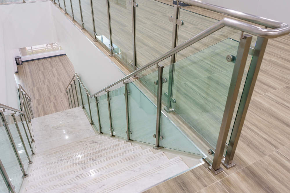 Modern,white,marble,stairs,with,steel,and,glass,railing,in